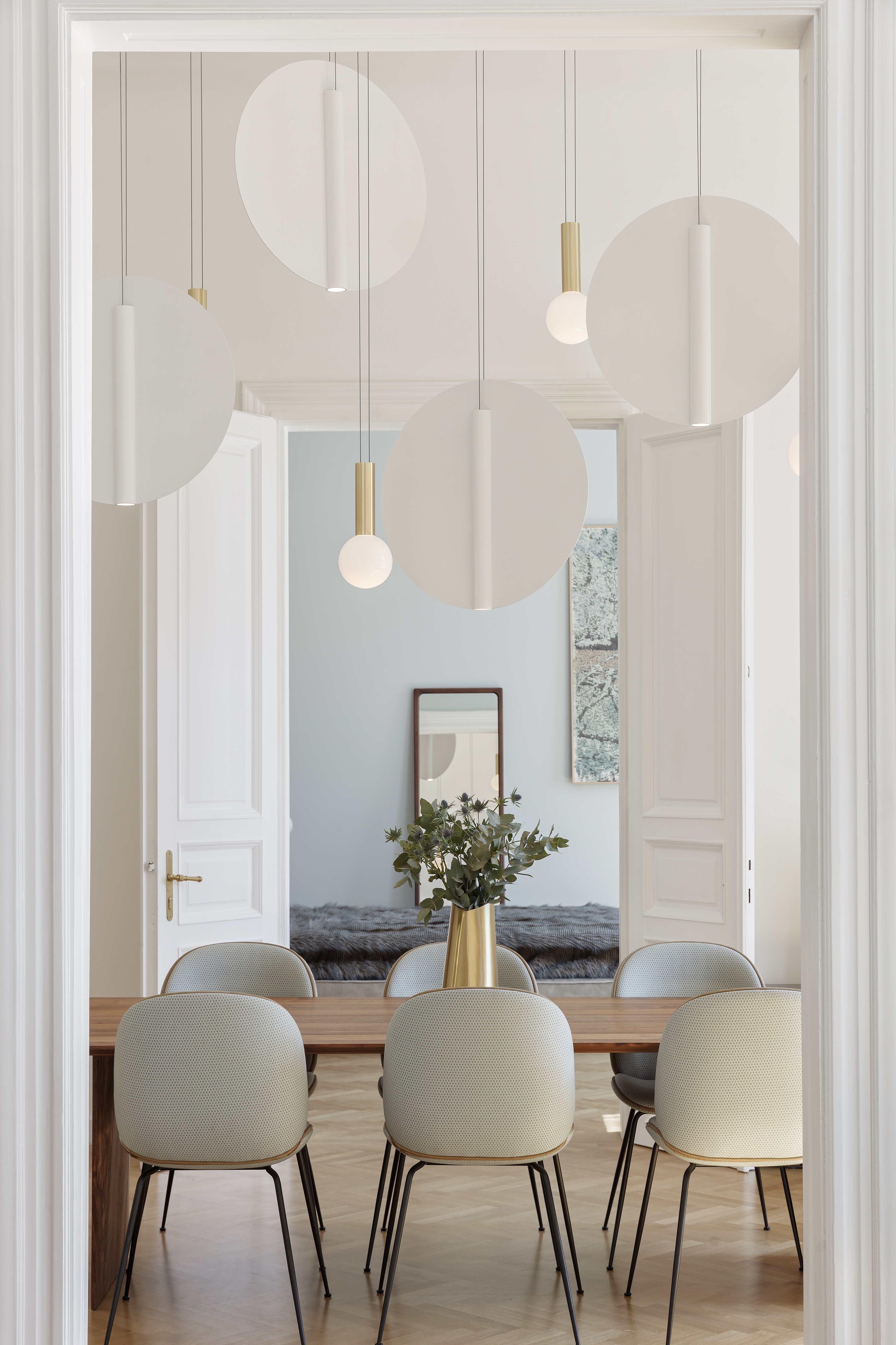 Cnidaria table lamp with smooth translucent glass form glowing softly against a dark studio background, evoking a calm, organic presence